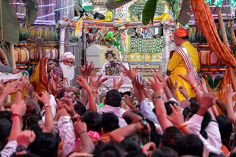 People scramble to collect 'Prasad' during the Nandotsav celebrations, the concluding event of 'Janmashtami' festivities, at Dwarkadhish Temple, in Mathura, Uttar Pradesh.