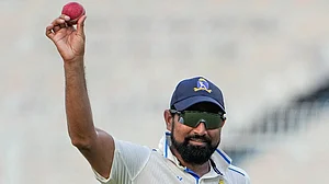 Photo: PTI/Swapan Mahapatra : Bengal pacer Mohammed Shami holds up the ball in celebration after claiming a five-wicket haul on the fourth day of the Ranji Trophy match against Gujarat, at Eden Gardens, Kolkata.