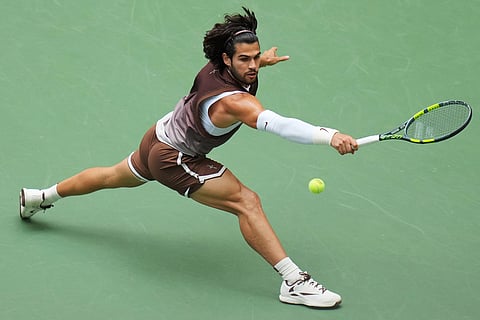 Carlos Alcaraz, of Spain, returns the ball to Wu Yibing, of China, during the third round of the U.S. Open tennis championships in New York. 