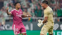 Real Madrid's Kylian Mbappe, left, reacts after missing a penalty kick in front of Betis' goalkeeper Alvaro Valles during the Spanish La Liga soccer match between Real Betis and Real Madrid in Seville. - Jose Breton/AP Photo