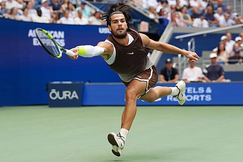 Carlos Alcaraz, of Spain, returns the ball to Wu Yibing, of China, during the third round of the U.S. Open tennis championships in New York.
