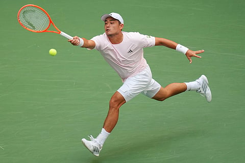 Wu Yibing, of China, returns the ball to Carlos Alcaraz, of Spain, during the third round of the U.S. Open tennis championships in New York.