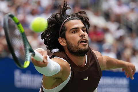 Carlos Alcaraz, of Spain, returns the ball to Wu Yibing, of China, during the third round of the U.S. Open tennis championships in New York.
