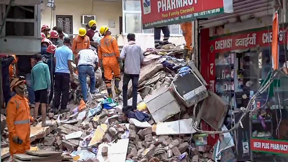 Rescue operation underway after a building collapsed at Satya Niketan area, in New Delhi, Sunday, Sept. 6, 2026.  - | Photo: PTI 
