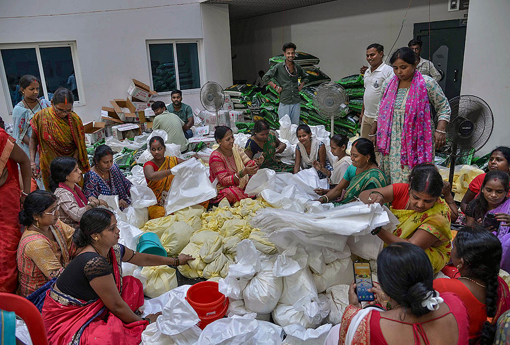 Volunteers prepare packets of relief supplies for flood-affected people