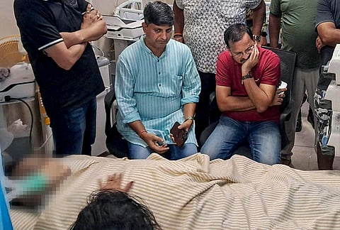 Family members and relatives sit next to Senior JMM leader and state Higher and Technical Education and Urban Development Minister Sudivya Kumar, who was undergoing treatment at a hospital, in Giridih district, Jharkhand. Kumar, 56, died of cardiac arrest at a private hospital in his hometown Giridih, officials said. 