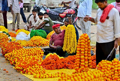 Prayagraj: Vendors wait for customers at a wholesale flower market, in Prayagraj, Uttar Pradesh.