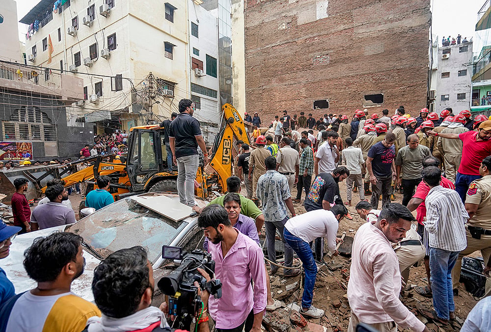 trapped under debris delhi building