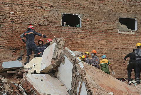 Rescue workers look for the trapped survivors under the debris of a building that collapsed in New Delhi, India, Sunday, Sept. 6, 2026.