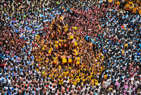 People form a human pyramid to break the 'Dahi Handi', an earthen pot filled with curd hanging above them, as part of the 'Janmastami' festival celebrations, in Mumbai, Maharashtra, Saturday, Sept. 5, 2026. 
