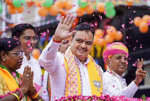 Rajasthan Chief Minister Bhajanlal Sharma greets supporters during a roadshow ahead of the Municipal Corporation elections, in Ajmer.