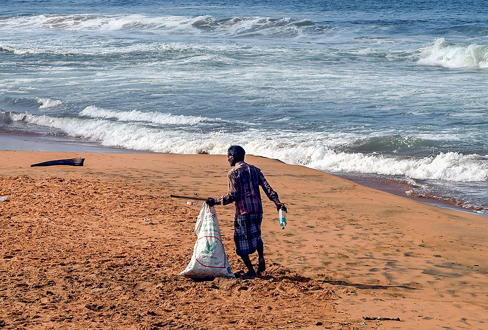 A man collects plastic bottles