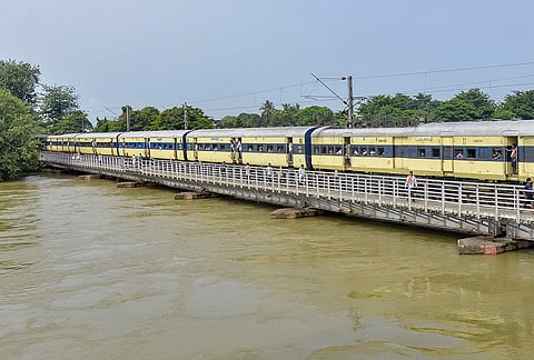 A passenger train crosses a flooded bridge following a rise in the water level of the Punpun river, in Patna, Bihar, Sunday, Sept. 6, 2026. 