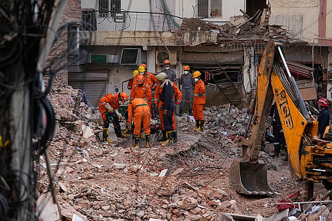 Rescue workers continue to search for people trapped under the debris of a collapsed building in New Delhi, India.