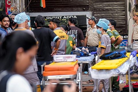 Medical officials at the site after a 50-year-old five-storey building housing a boys' hostel collapsed in a congested bylane in Satya Niketan near Delhi University’s south campus. Three died in the incident.