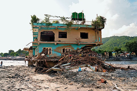 Defiance Amid Devastation: A lone house stands intact in Devighat in Nuwakot district 