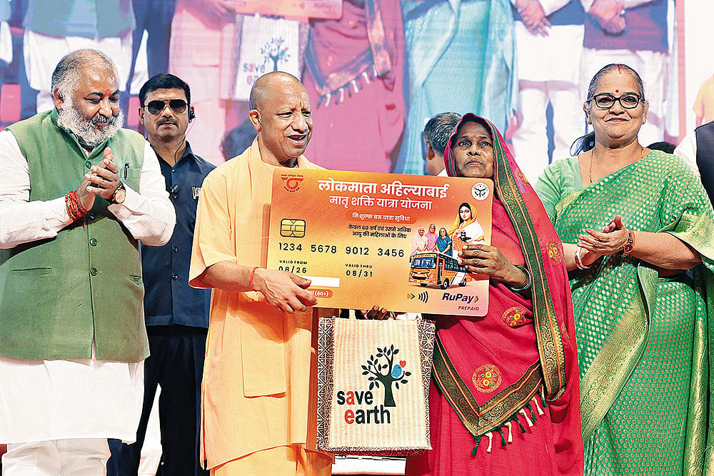 Schemes Galore: Uttar Pradesh Chief Minister Yogi Adityanath presents a travel card to an elderly woman in Lucknow on August 26, 2026 - | Photos: Imago