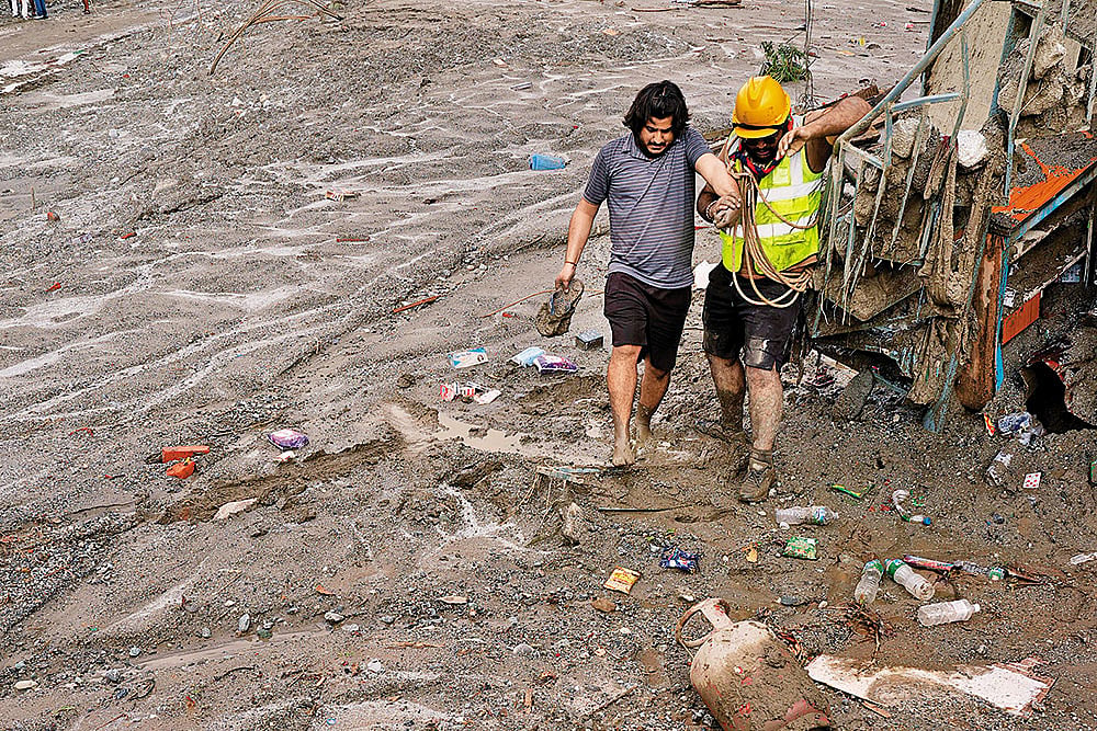A Nepal Scout helping a survivor