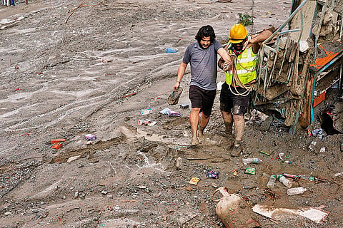 Helping Hand: A Nepal Scout helping a survivor