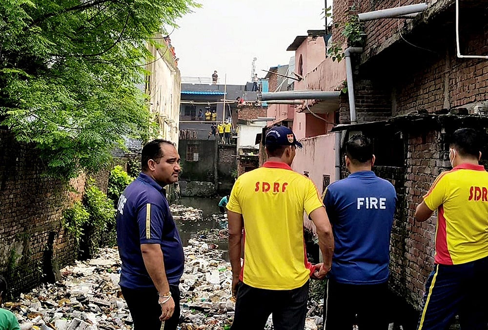 SDRF and Fire services personnel during a rescue operation after two children were allegedly swept away by a strong current in a drain, in Haridwar, Uttarakhand. - | Photo: PTI