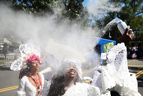 Members of the Belmont Baby Dolls throw baby powder as they wait for the start of the West Indian Day Parade on Monday, Sept. 7, 2026, in the Brooklyn borough of New York. 