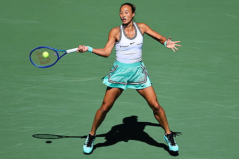 Qinwen Zheng, of China, returns the ball to Iga Swiatek, of Poland, during the fourth round of the U.S. Open tennis championships in New York.