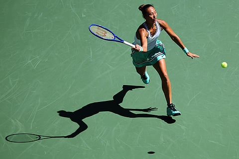 Qinwen Zheng, of China, returns the ball to Iga Swiatek, of Poland, during the fourth round of the U.S. Open tennis championships in New York.
