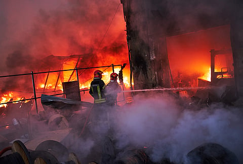 Firefighters try to extinguish a fire following a Russian missile attack in Kyiv, Ukraine, early Tuesday, Sept. 8, 2026. 