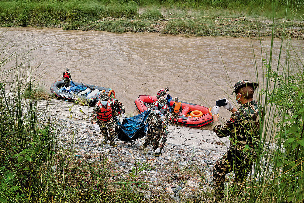 The Vulnerable Downstream: Nepali soldiers recover the bodies of flash flood victims from a river in Chitwan, Nepal, on August 31, 2026 - | Photo: AP