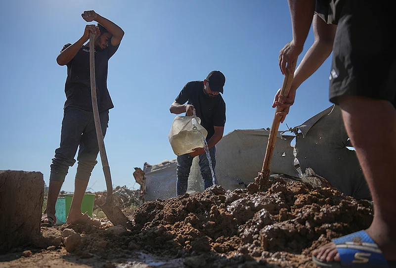 Palestinians building with mud bricks