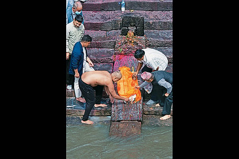 No Closure: Family members hold a symbolic funeral of a child at Arya Ghat inside Pashupati Nath Temple, Kathmandu
