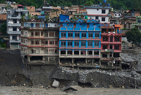 Houses damaged by flash floods are seen on the bank of Trishuli river in Dhunge, Nuwakot district, Nepal, Monday, Sept. 7, 2026. 