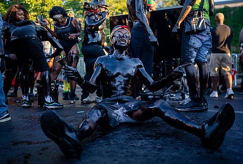 People participate in J'Ouvert festivities ahead of the West Indian Day Parade at sunrise on Labor Day in the Crown Heights and Flatbush neighborhoods of Brooklyn, Monday, Sept. 7, 2026, in New York. 