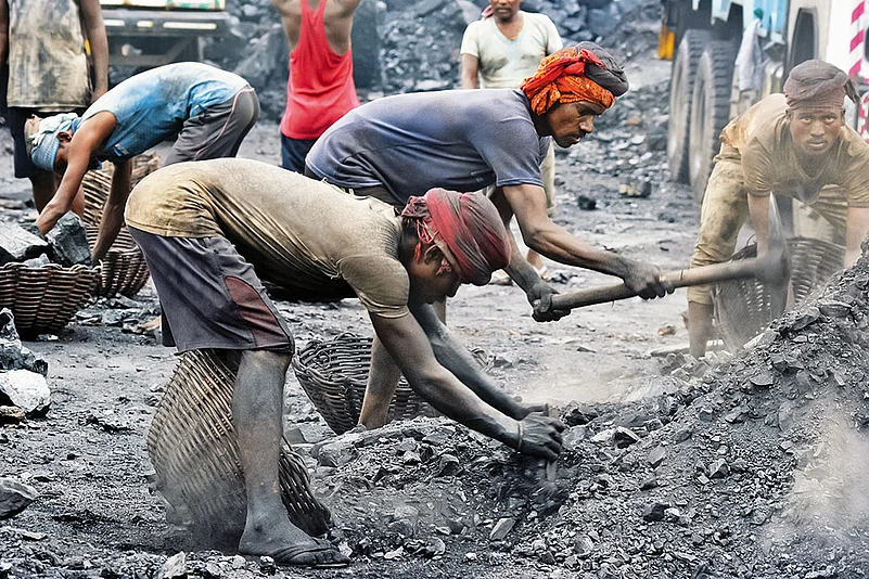 Coal workers toiling at a mine