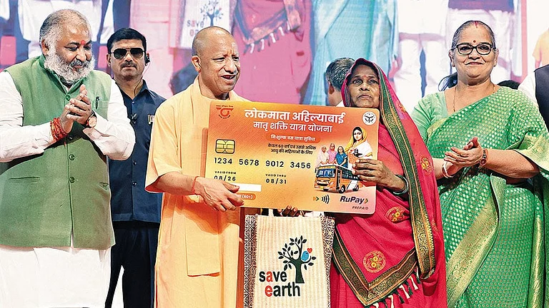 Schemes Galore: Uttar Pradesh Chief Minister Yogi Adityanath presents a travel card to an elderly woman in Lucknow on August 26, 2026 - | Photos: Imago