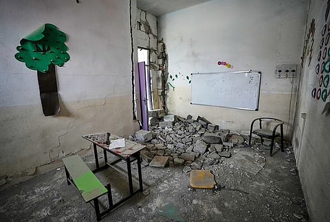 A tree-shaped decoration remains on the wall of a rubble-strewn classroom at the Shajareh Tayyebeh school, damaged in a Feb. 28 U.S. airstrike in Minab, southern Iran, Monday, Sept. 7, 2026. 