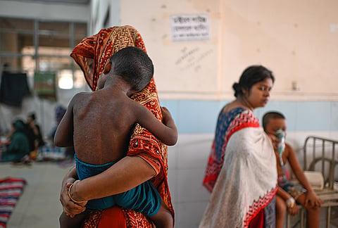 A woman brings her child for treatment of measles outbreak in a hospital in Dhaka, Bangladesh, Tuesday, Sept. 8, 2026. 