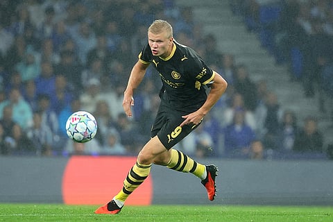 Manchester City's Erling Haaland runs after the ball during a Champions League opening phase soccer match between FC Porto and Manchester City in Porto, Portugal.