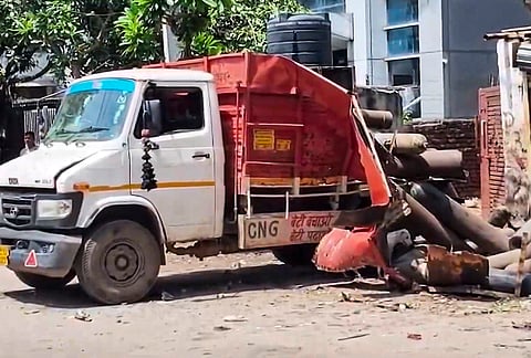 A truck lies damaged after an oxygen cylinder exploded while it was being unloaded from the truck at a commercial godown, at Okhla Phase-I, in New Delhi. At least one person was killed and four others were injured in the incident. 