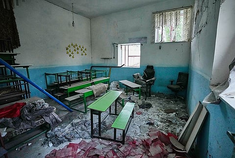 Classroom desks and chairs sit amid rubble at the Shajareh Tayyebeh school, damaged in a Feb. 28 U.S. airstrike in Minab, southern Iran, Monday, Sept. 7, 2026. 
