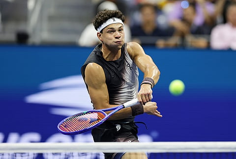 Ben Shelton, of the United States, hits an overheard return in the fifth set against Carlos Alcaraz, of Spain, during the quarterfinal round of the U.S. Open tennis championships, early Wednesday, Sept. 9, 2026, in New York.