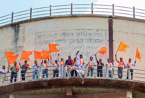 Maratha community activists demonstrate atop a water tank in support of activist Manoj Jarange Patil's indefinite hunger strike for quota demands, in Solapur, Maharashtra.