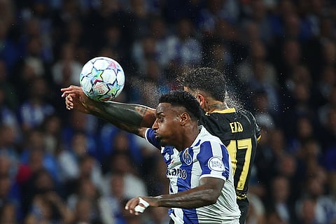 Porto's Pablo Rosario jumps for the ball with Manchester City's Enzo Fernandez, right, during a Champions League opening phase soccer match between FC Porto and Manchester City in Porto, Portugal.