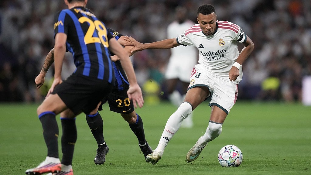 Real Madrid's Kylian Mbappe fights for the ball against Inter Milan's Hakan Calhanoglu before scoring the opening goal, during a Champions League soccer match between Real Madrid and Inter Milan in Madrid, Spain. - Bernat Armangue/AP Photo