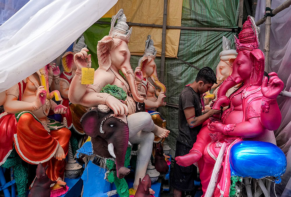 An artist gives final touches to an idol of lord Ganesh ahead of the Ganesh Chaturthi festival, at Kumartuli, in Kolkata, West Bengal, Sunday, Sept. 6, 2026. 