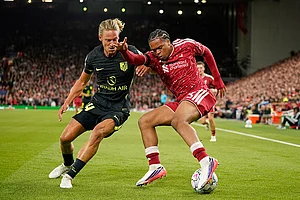 | Photo: AP/Dave Thompson : Liverpool's Rio Ngumoha and Atletico Madrid's Marcos Llorente challenge for the ball during the Champions League opening phase soccer match between Liverpool and Atletico Madrid in Liverpool, England.