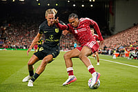 | Photo: AP/Dave Thompson : Liverpool's Rio Ngumoha and Atletico Madrid's Marcos Llorente challenge for the ball during the Champions League opening phase soccer match between Liverpool and Atletico Madrid in Liverpool, England.