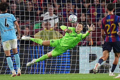 Feyenoord's goalkeeper Tjark Ernst makes a save during the Champions League opening phase soccer between Barcelona and Feyenoord in Barcelona, Spain.