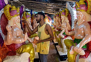 | Photo: PTI : An artist prepares an idol of Lord Vishwakarma at a workshop ahead of the Vishwakarma Puja festival, in Gurugram, Haryana.