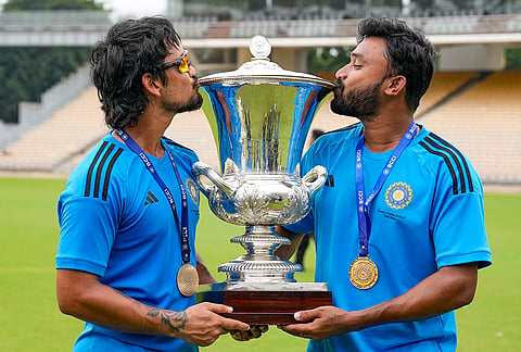 East Zone's captain Ishan Kishan, left, and Abhijit Sarkar kiss the trophy after winning the Duleep Trophy 2026-27, in Chennai, Tamil Nadu, Thursday, Sept. 10, 2026. 